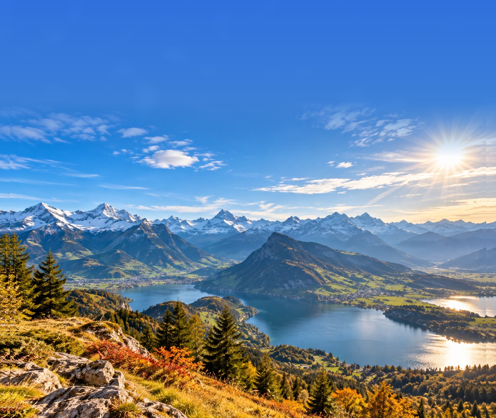 Sonniger Spätsommertag über einer Schweizer Alpen- und Seenlandschaft Ende September.